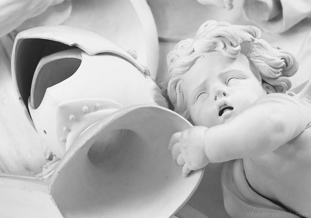 Child with helmet in a anti-war detail of stucco by Giacomo Serpotta stuccoes in Oratorio del Rosario di Santa Cita